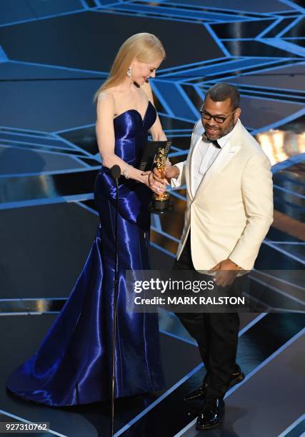 Director Jordan Peele accepts the Oscar for Best Original Screenplay for "Get Out" from Australian actress Nicole Kidman during the 90th Annual...