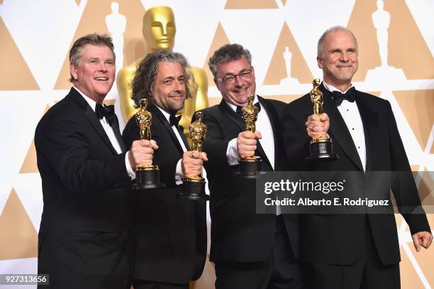 Visual effects artists Richard R. Hoover, Paul Lambert, Gerd Nefzer, and John Nelson, winners of the Best Visual Effects award for 'Blade Runner...