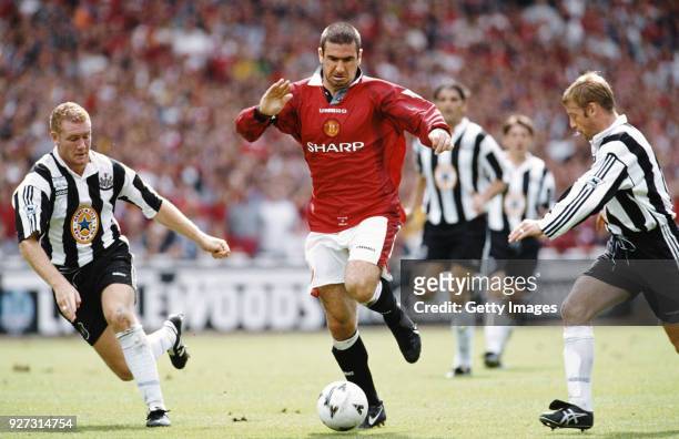Manchester United player Eric Cantona beats Steve Watson and David Batty during the FA Charity Shield match between Manchester United and Newcastle...