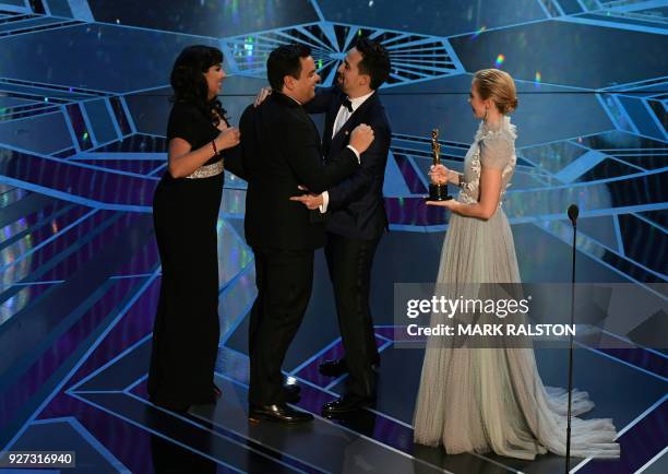 Composers Kristen Anderson-Lopez and Robert Lopez accepts the Oscar for Best Original Song for "Remember Me" from Coco from US composer Lin-Manuel...