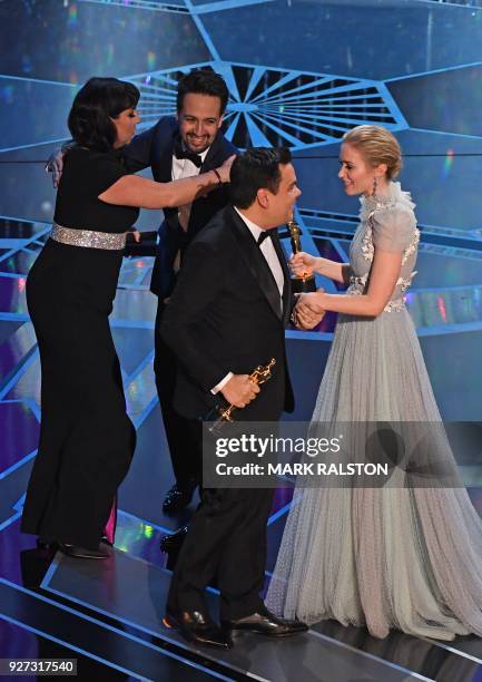 Composers Kristen Anderson-Lopez and Robert Lopez accept the Oscar for Best Original Song for "Remember Me" from Coco from US composer Lin-Manuel...