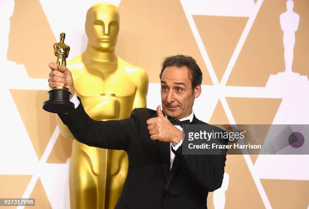 Composer Alexandre Desplat, winner of the Best Original Score award for 'The Shape of Water,' poses in the press room during the 90th Annual Academy...
