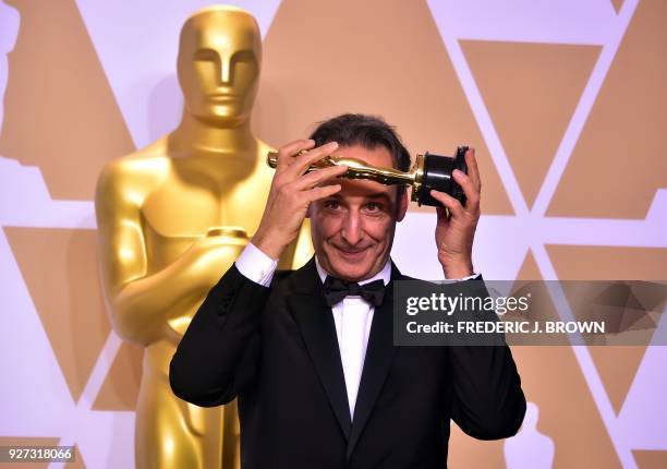 French composer Alexandre Desplat poses in the press room with the Oscar for Best Original Score for "The Shape of Water," during the 90th Annual...