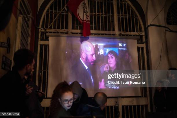 Party militants Power to the world within the former EX OGP social center during the counting of the paper ballots on March 4, 2018 in Naples, Italy....