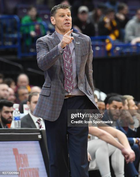 Loyola basketball coach Porter Moser communicates with his team during a Missouri Valley Conference Basketball Tournament game between Loyola...