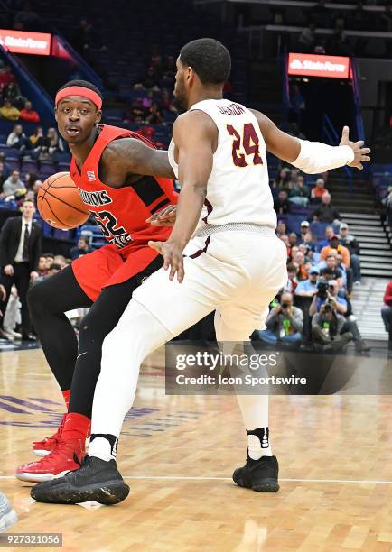 Illinois State guard Milik Yarbrough tries to drive around Loyola guard Andre Jackson during a Missouri Valley Conference Basketball Tournament game...