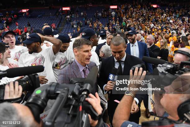 Loyola basketball coach Porter Moser is surrounded by media after winning the Missouri Valley Conference Basketball Tournament game championship...