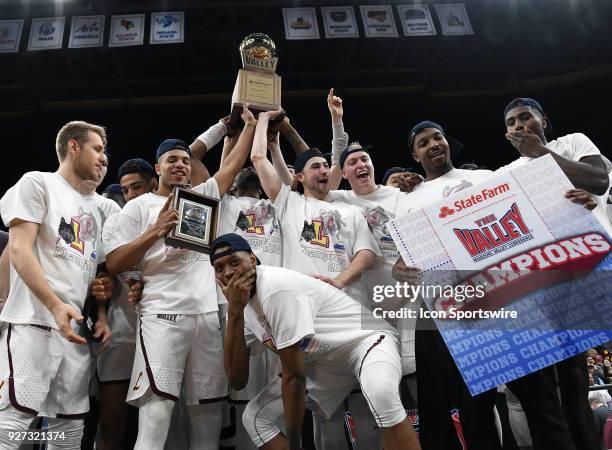 Loyola players celebrate with the championship trophy after winning the Missouri Valley Conference Basketball Tournament championship game between...