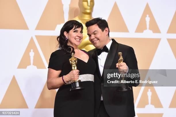 Composers Kristen Anderson-Lopez and Robert Lopez, winners of the Best Original Song award for 'Remember Me' from 'Coco,' pose in the press room...