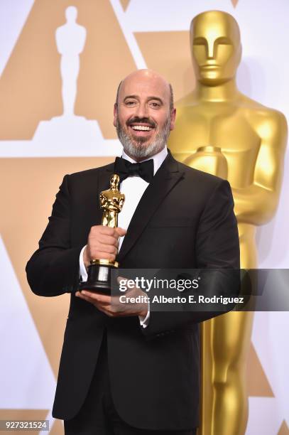 Costume designer Mark Bridges, winner of the Best Costume Design award for 'Phantom Thread,' poses in the press room during the 90th Annual Academy...