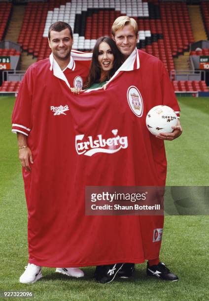 Liverpool players Steve Harkness and John Scales join model Kathy Lloyd as they pose in the new Liverpool home kit at the launch of the 1996/97...