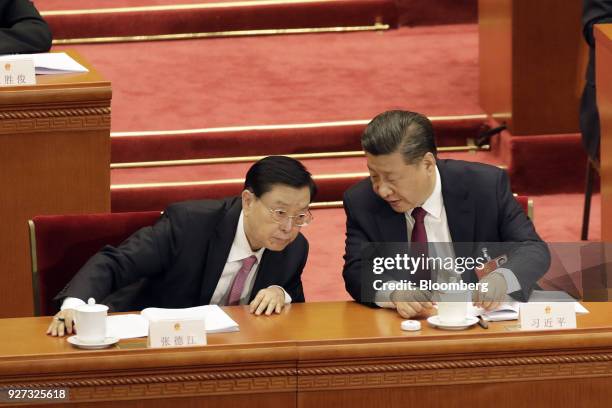 Xi Jinping, China's president, right, speaks with Zhang Dejiang, chairman of the Standing Committee of the National People's Congress , during the...