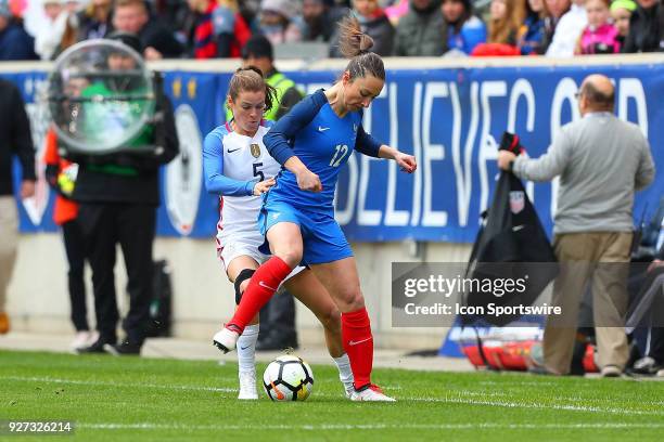 France defender midfielder Gaetane Thiney battles United States of America defender Kelley O'Hara during the first half the SheBelieves Cup Womens...