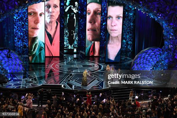 Actress Frances McDormand delivers a speech next to US actresses Jodie Foster and Jennifer Lawrence after she won the Oscar for Best Actress in...