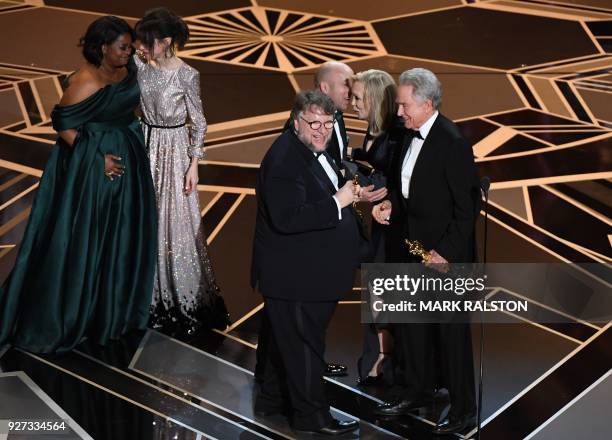 Mexican director Guillermo del Toro and producer J. Miles Dale accept the Oscar for Best Film for "The Shape of Water" from US actors Faye Dunaway...