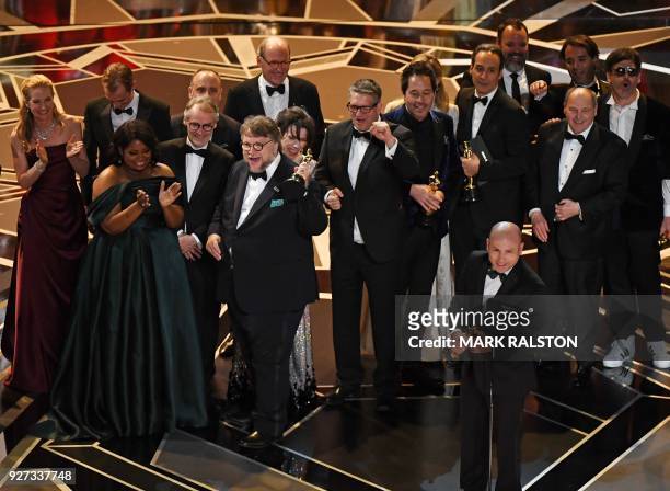 Producer J. Miles Dale delivers a speech after he and Mexican director Guillermo del Toro won the Oscar for Best Film for "The Shape of Water" during...