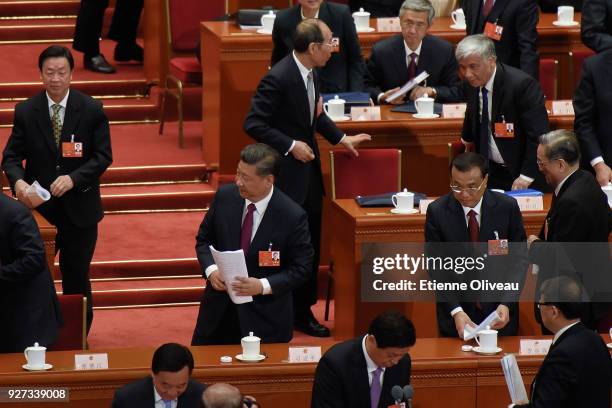 Chinese President Xi Jinping and Chinese Premier Li Keqiang leave The Great Hall of People after the opening session of the 13th National People's...