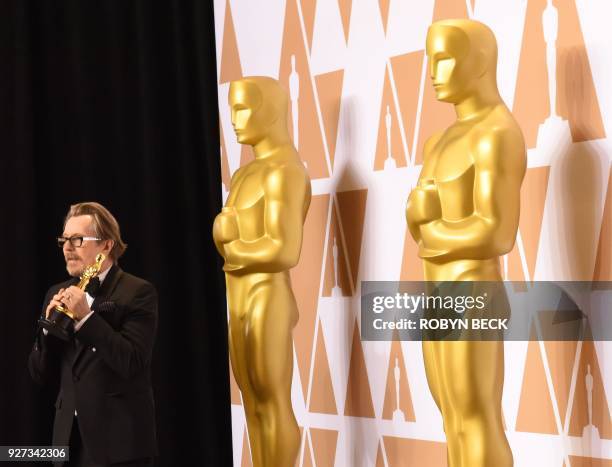 British actor Gary Oldman poses in the press room with the Oscar for Best Actor in "Darkest Hour" during the 90th Annual Academy Awards on March 4 in...
