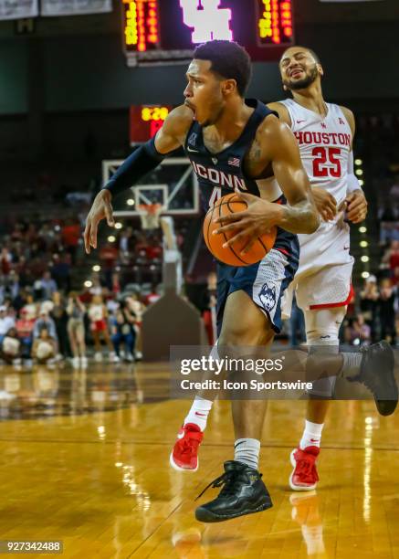 Connecticut Huskies guard Jalen Adams drives the ball pastHouston Cougars guard Galen Robinson Jr. During the men's basketball game between the UConn...