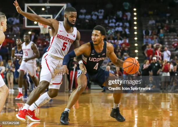 Connecticut Huskies guard Jalen Adams brakes and drives the ball past Houston Cougars guard Corey Davis Jr. During the men's basketball game between...