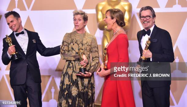 Actors Sam Rockwell, Frances McDormand, Allison Janney, and Gary Oldman, pose in the press room with their Oscars for best supporting actor, best...
