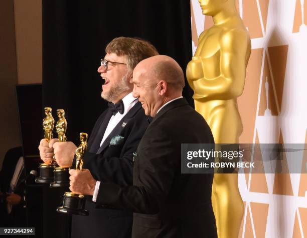 Mexican director Guillermo del Toro and producer J. Miles Dale pose in the press room with the Oscar for Best Film for "The Shape of Water" during...