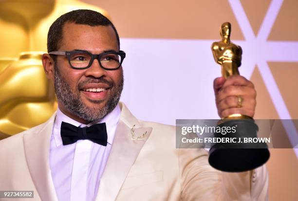 Director Jordan Peele poses in the press room with the Oscar for best original screenplay during the 90th Annual Academy Awards on March 4 in...