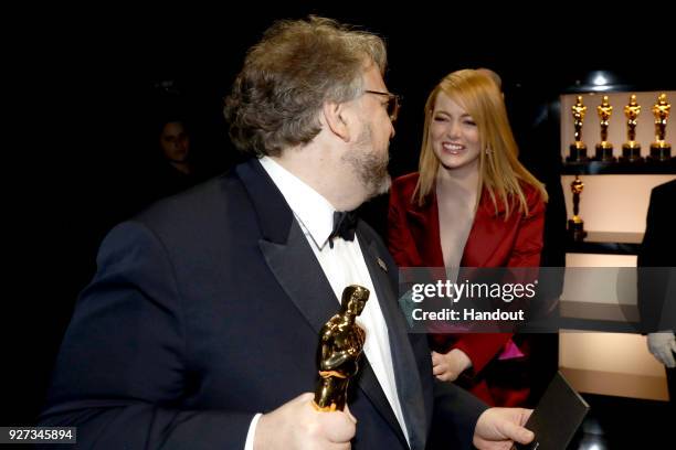 In this handout provided by A.M.P.A.S., Guillermo del Toro , winner of the Best Director and Best Picture awards for 'The Shape of Water,' and Emma...