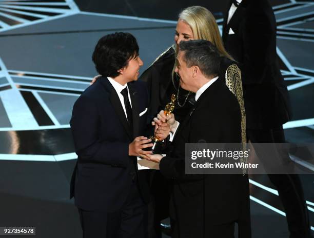 Actor Anthony Gonzalez, co-director Lee Unkrich, and producer Darla K. Anderson accept Best Animated Feature Film for 'Coco' onstage during the 90th...