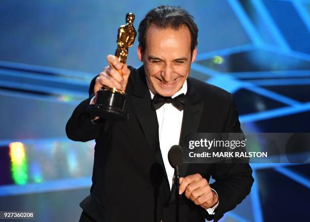 French composer Alexandre Desplat smiles after he won the Oscar for Best Original Score for "The Shape of Water" during the 90th Annual Academy...