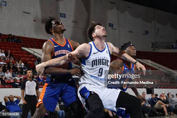 Byron Mullens of the Lakeland Magic boxes out against Nigek Hayes and Devon Baulkman of the Westchester Knicks during the game on March 4, 2018 at RP...