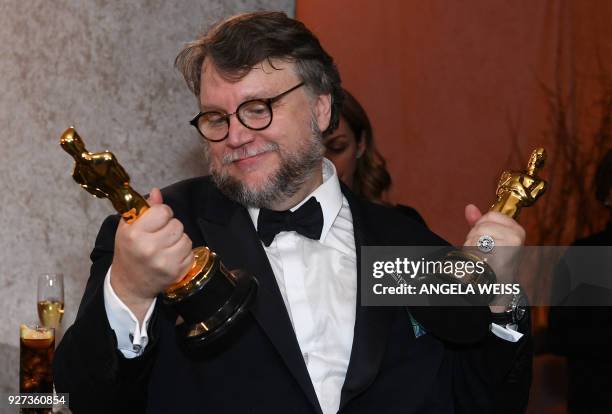 Best Director and Best Film laureate Mexican director Guillermo del Toro stands at the engraving station as he attends the 90th Annual Academy Awards...