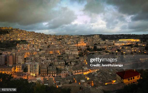 modica, sicily: panorama of city at night; st george cathedral - modica sicily stock pictures, royalty-free photos & images