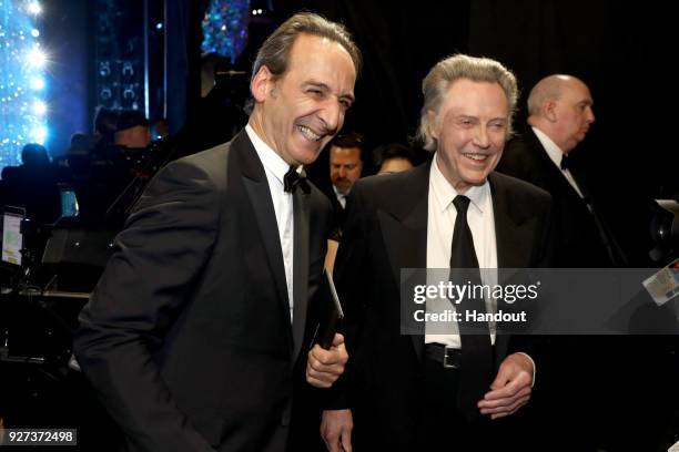 In this handout provided by A.M.P.A.S., Alexandre Desplat , winner Best Original Score for 'The Shape of Water and Christopher Walken attends the...