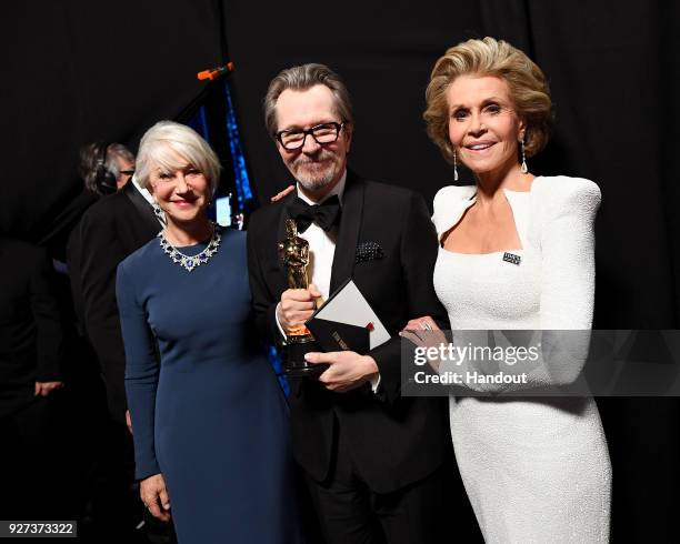 In this handout provided by A.M.P.A.S., actor Helen Mirren, actor Gary Oldman, winner of the Best Actor award for 'Darkest Hour,' and actor Jane...