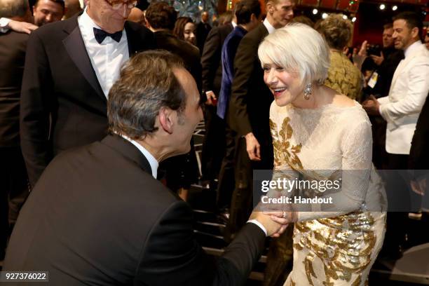 In this handout provided by A.M.P.A.S., Alexandre Desplat and Helen Mirren attend the 90th Annual Academy Awards at the Dolby Theatre on March 4,...