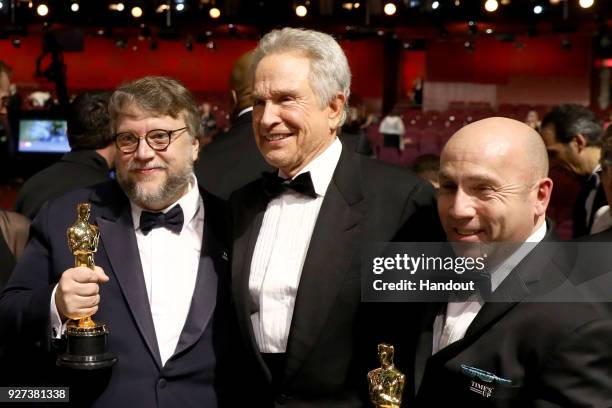 In this handout provided by A.M.P.A.S., Guillermo Del Toro, Warren Beatty and J. Miles Dale attend the 90th Annual Academy Awards at the Dolby...