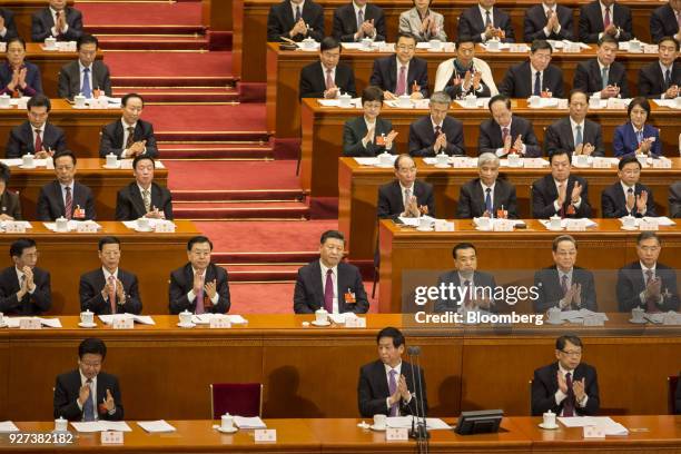 Xi Jinping, China's president, center, looks on as Wang Huning, member of the Communist Party of China's Politburo Standing Committee, second row...