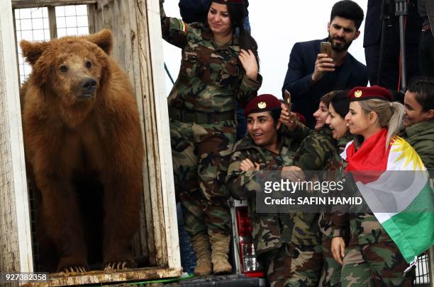 Female Iraqi Kurdish peshmerga fighters watch on as they release a bear into the wild in the Gara Mountains near the northern Iraqi city of Dohuk on...