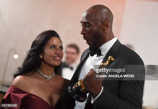 Actor and basketball player Kobe Bryant holds an oscar beside his wife Vanessa Laine Bryant during the 90th Annual Academy Awards on March 4 in...