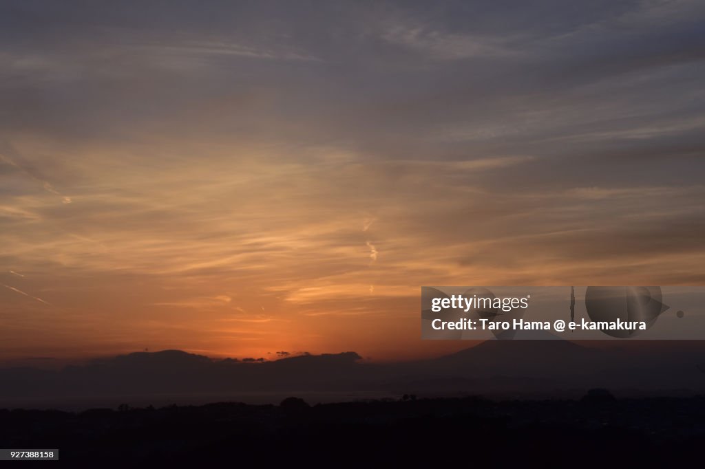 Orange-colored sunset clouds on Mt. Fuji and Sagami Bay in Kanagawa prefecture in Japan