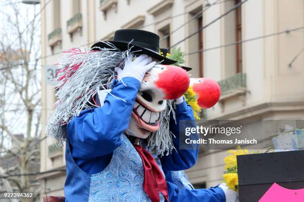 waggis covering his eyes on a carriage during the parade of the basler fasnacht - waggis stock pictures, royalty-free photos & images
