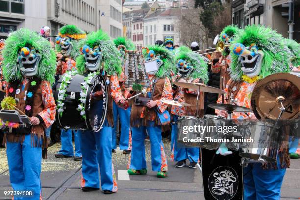 a marching brass band with waggis masks playing guggenmusik at the basler fasnacht - waggis stock pictures, royalty-free photos & images