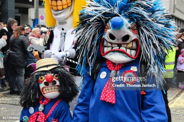 small and large waggis during the parade of the basler fasnacht - waggis stock pictures, royalty-free photos & images