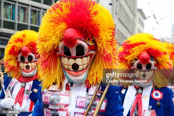 a marching brass band with waggis masks playing guggenmusik at the basler fasnacht - waggis stock pictures, royalty-free photos & images
