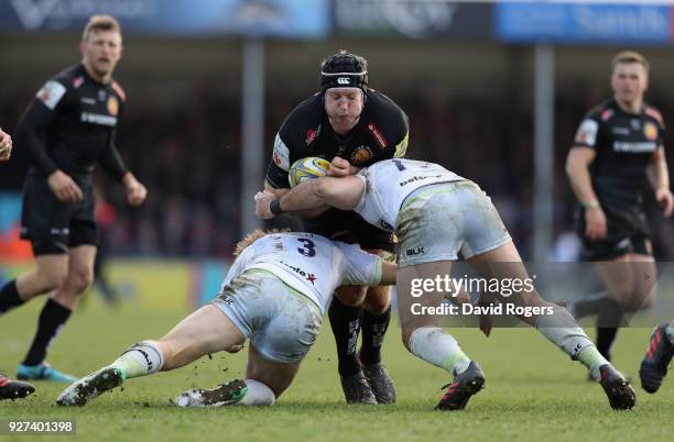 Thomas Waldrom of Exeter is tackled during the Aviva Premiership match between Exeter Chiefs and Saracens at Sandy Park on March 4, 2018 in Exeter,...