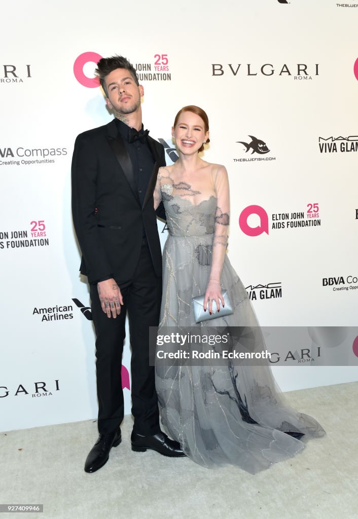 Travis Mills and Madelaine Petsch attend the 26th annual Elton John
