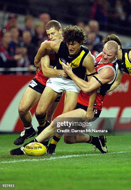 Darren Gaspar for Richmond is tackled on the boundary by Brett Voss and Barry Hall for St Kilda, in the match between the St Kilda Saints and the...