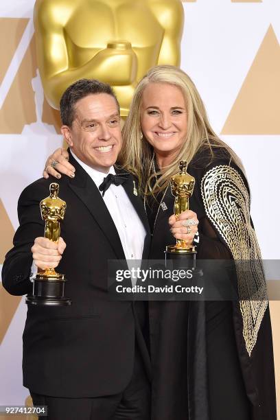 Lee Unkrich and Darla K. Anderson attend the 90th Annual Academy Awards - Press Room on March 4, 2018 in Hollywood, California.