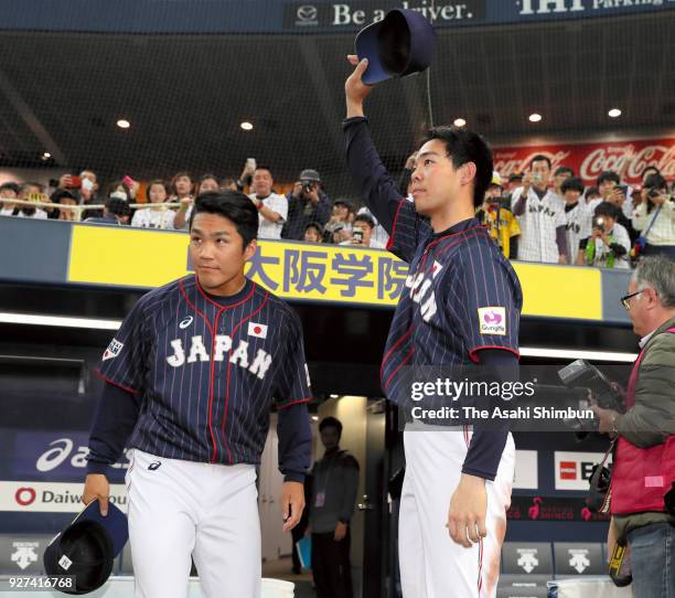 Takahiro Norimoto and Shogo Akiyama of Japan applaud supporters after their 609 victory in the game two of the baseball international match between...